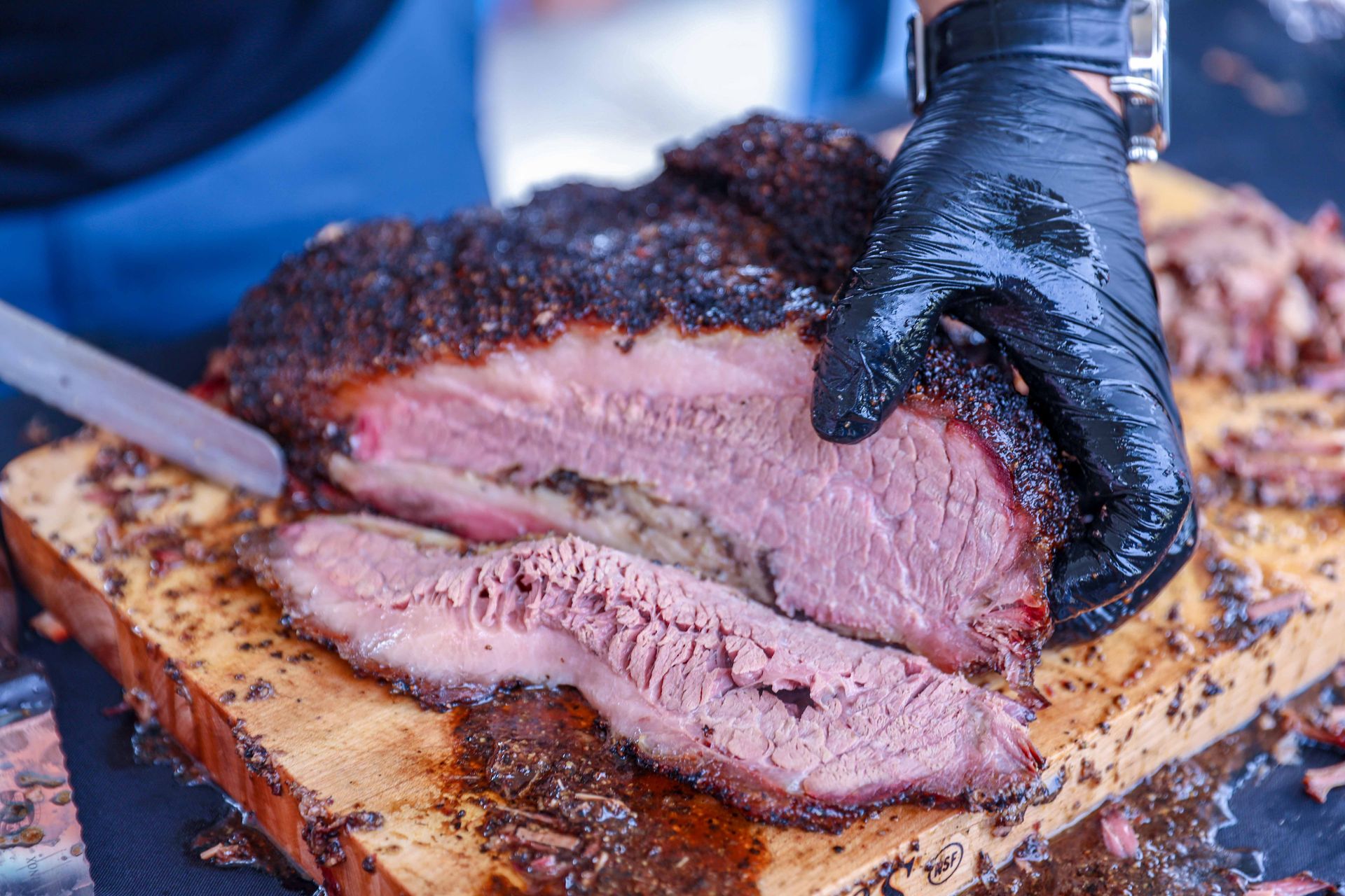 Pitmaster slicing smoked barbecue